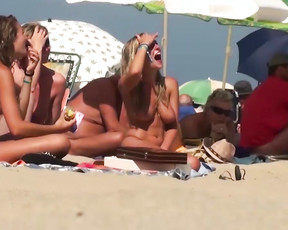 Nude beach girls are all topless as they are soaking up the sun