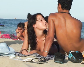 Playful brunette is a young nudist who loves going to the beach topless with her boyfriend