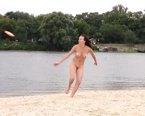 Two wicked nude beach girls with shaved pussies are playing frisbee together